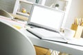 Modern workspace with empty white laptop screen Royalty Free Stock Photo