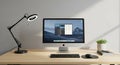 Modern workspace featuring an Apple iMac with a mountain landscape wallpaper on its screen. A black Royalty Free Stock Photo