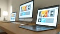 Modern workspace featuring a laptop computer a desktop display and a tablet showcasing a clean and professional website design Royalty Free Stock Photo