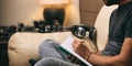 Left handed man writing, sitting on a sofa Royalty Free Stock Photo