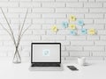 Modern workspace with laptop, coffee, and sticky notes on white brick wall isolated on white background Royalty Free Stock Photo
