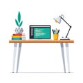 Modern workspace with laptop displaying code, books, desk lamp, and plant for creative home office setup Royalty Free Stock Photo