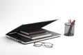 Modern workspace with laptop keyboard, notebook, spectacles on white background