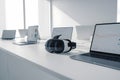 Modern workspace with multiple devices and headphones Royalty Free Stock Photo