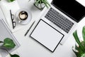 Modern Workspace Setup: Laptop, Tablet, Coffee, and Plants Royalty Free Stock Photo