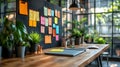 modern creative workspace with colorful sticky notes on blackboard and plants on wooden desk in bright office room Royalty Free Stock Photo