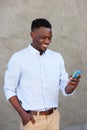 Modern young black man reading text message on his mobile phone Royalty Free Stock Photo