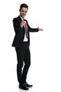 Modern young businessman presenting and pointing forward Royalty Free Stock Photo