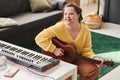 Cheerful Girl With Down Syndrome Playing Guitar Royalty Free Stock Photo