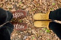 Modern young couple in hiking boots standing fallen autumn leaves in the forest outdoor travel concept top view Love forever