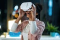 Modern young entrepreneur woman using virtual reality headset and enjoying the moment in the office Royalty Free Stock Photo