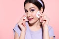 Modern young girl cleansing face, using cotton pads. Royalty Free Stock Photo