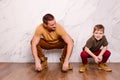 A modern young man and an eight-year-old cheerful boy in orange shoes. father`s day