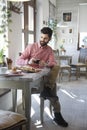 Modern young man sitting in coffee shop Royalty Free Stock Photo