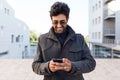 Modern young man using his mobile phone in the street. Royalty Free Stock Photo