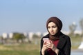 Modern young muslim woman typing message with her smartphone Royalty Free Stock Photo