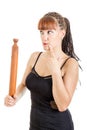 Modern young woman in the kitchen with rolling pin