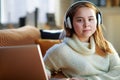 Modern young woman listening to music while and laptop Royalty Free Stock Photo