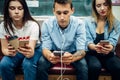 Modern youth using phones in subway, addiction