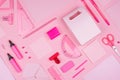 Modern youth workplace - neon pink stationery as decorative pattern on pink background, top view.