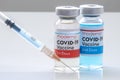 A Moderna 1st dosis and a 2nd dosis of covid-19 vaccine on a vial bottle and injection