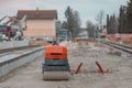 Modernisation of older train station of Domzale, suburb city of ljubljana. Workers laying new tracks with gravel and new