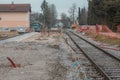 Modernisation of older train station of Domzale, suburb city of ljubljana. Workers laying new tracks with gravel and new