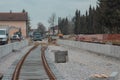 Modernization of older train station of Domzale, suburb city of ljubljana. Workers laying new tracks with gravel and new