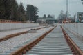 Modernization of older train station of Domzale, suburb city of ljubljana. Workers laying new tracks with gravel and new