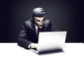 Modernized hacker with laptop. Concept of cybercrime, cyberattack. AI generated image