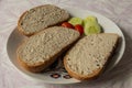 A modest breakfast in the form of three breads with fish spread and as a side dish are small tomatoes and sliced cucumber. Royalty Free Stock Photo