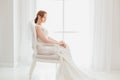 Modest bride sitting on a chair.