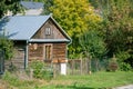 Modest old wooden cottage in Poland. Surrounded by greenery with plants and trees Royalty Free Stock Photo