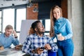 Modest secretary is offering tea to her Afruican chief during break Royalty Free Stock Photo