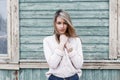 Modest young girl on the background of the old wooden wall with Royalty Free Stock Photo