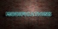 MODIFICATIONS - fluorescent Neon tube Sign on brickwork - Front view - 3D rendered royalty free stock picture Royalty Free Stock Photo