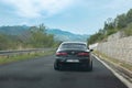 Modified Alfa Romeo 156 seen on the road driving on a warm sunny day. Mountains and sky in the distance. Part of Croatian italian Royalty Free Stock Photo