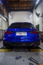 Modified blue Audi RS6 avant in car workshop