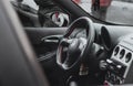 Modified interior of an Alfa Romeo 156. Improved black steering wheel with red stitiching, completely black interior Royalty Free Stock Photo