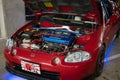 Modified Mugen engine of the red Honda CR-X Del Sol parked in the parking lot
