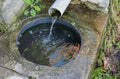 Modified natural spring. Water flows out of the felt pipe Royalty Free Stock Photo