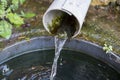 Modified natural spring. Water flows out of the felt pipe Royalty Free Stock Photo