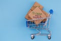 Modified photo of parcel with SberMegaMarket logo in the shopping cart on a blue background