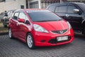 Modified red Honda Jazz or Honda Fit in car parking lot