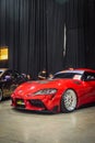 Modified red Toyota GR Supra MK V A91 in Black Auto Battle