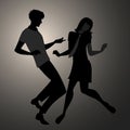 We are Mods. Silhouettes of couple wearing retro clothes in the 1960s Mod style dancing Royalty Free Stock Photo