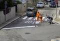 Machine and workers at road construction use for road and traffic sign painting