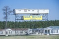 Modular home elevated on scaffold structure advertising Moore Housing company, MS