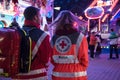 MOELLN, GERMANY, NOVEMBER 1, 2018: young man and woman from behind from the german red cross with rescue backpack for emergency f