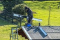 Moers , Germany - February 05 2018 : Roofer balancing on roof with metal facing